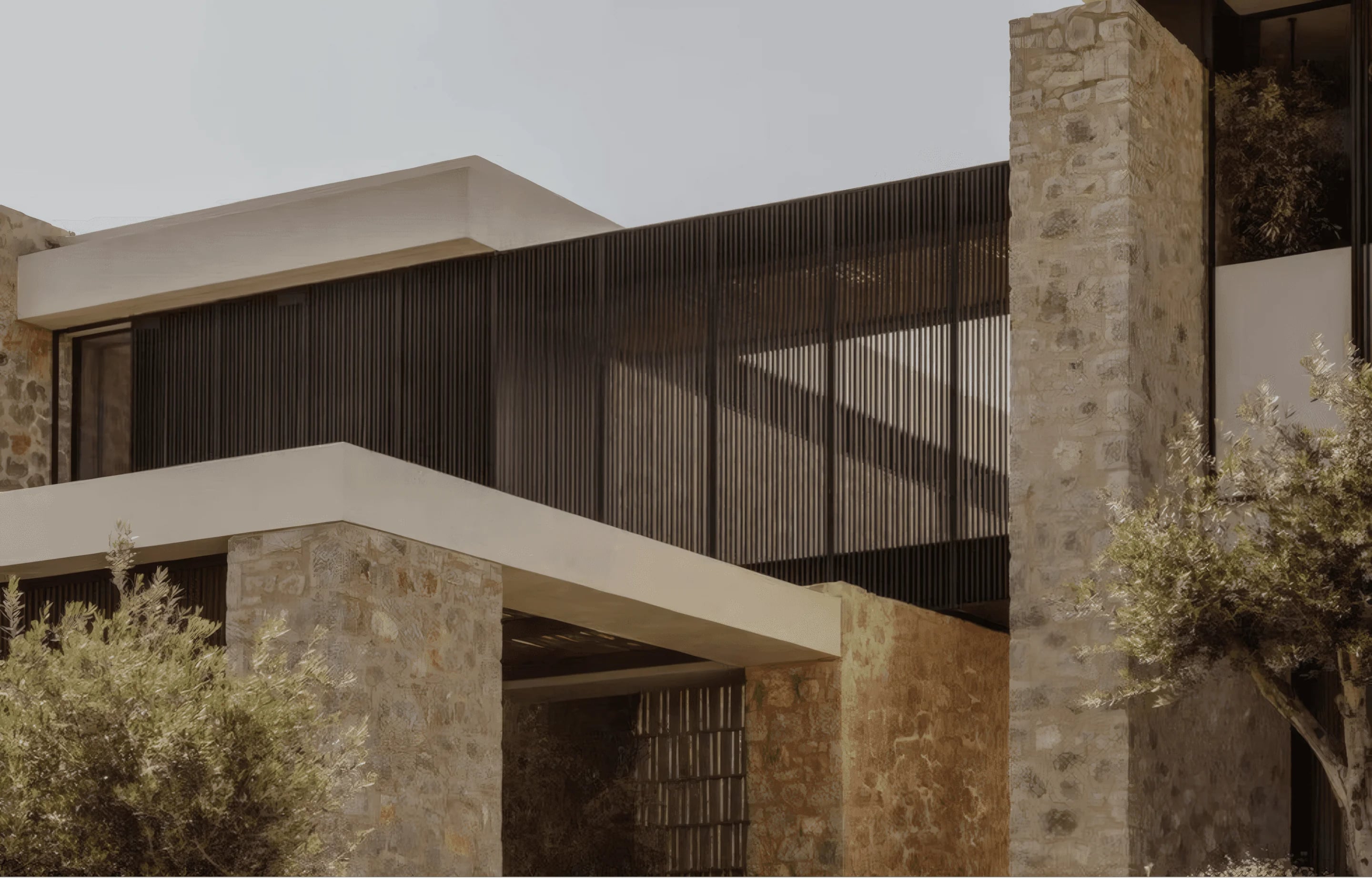 A contemporary house of stone walls, timber screens and olive trees